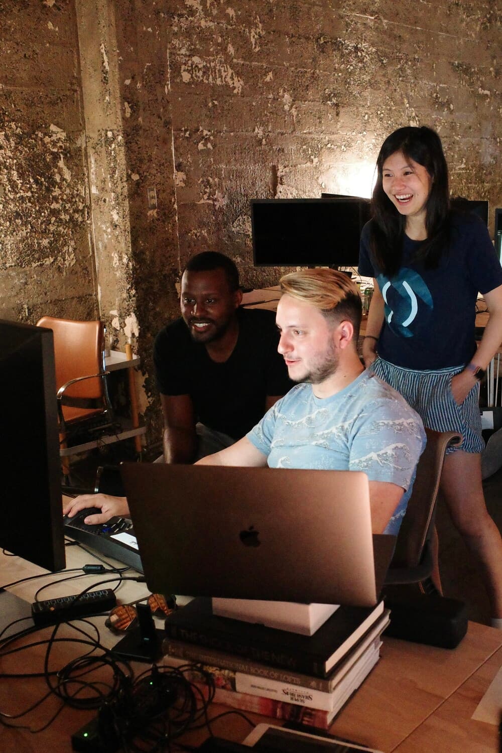 Picture of early Notion days, two employees around a laptop