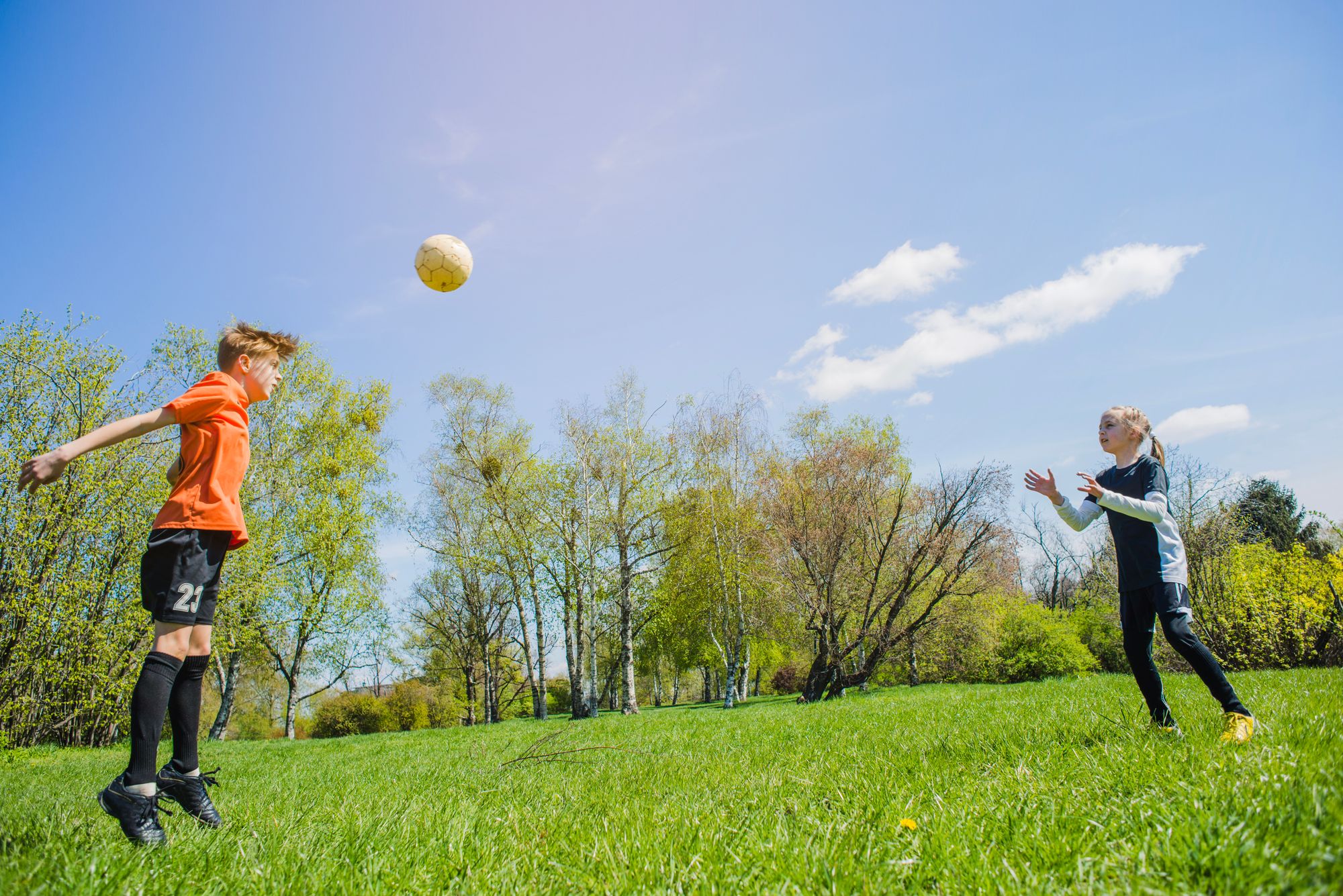   “Two kids playing soccer in the park”,  Image by "FreePik"