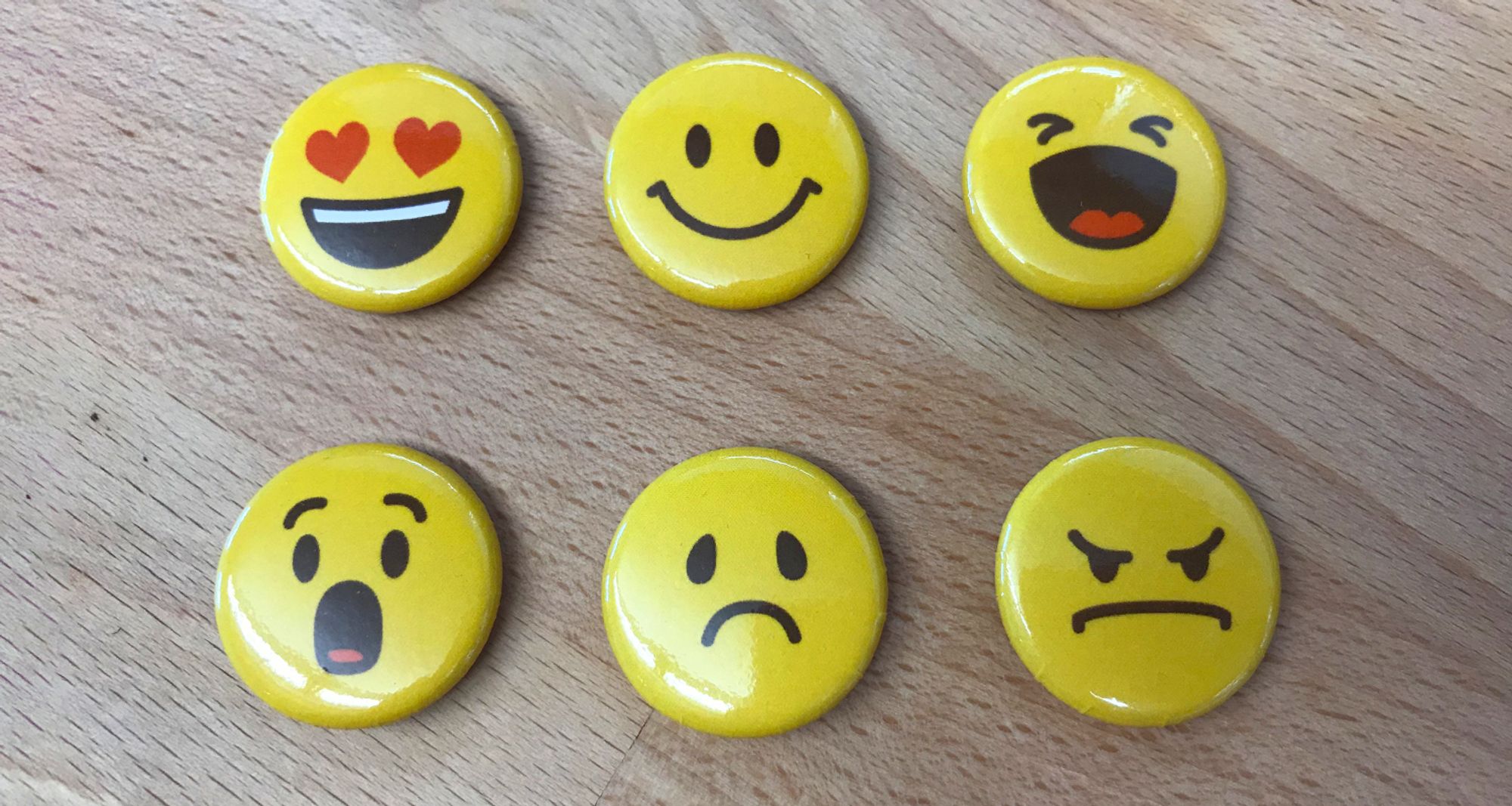 Photo of my illustrated emoji made into physical pins