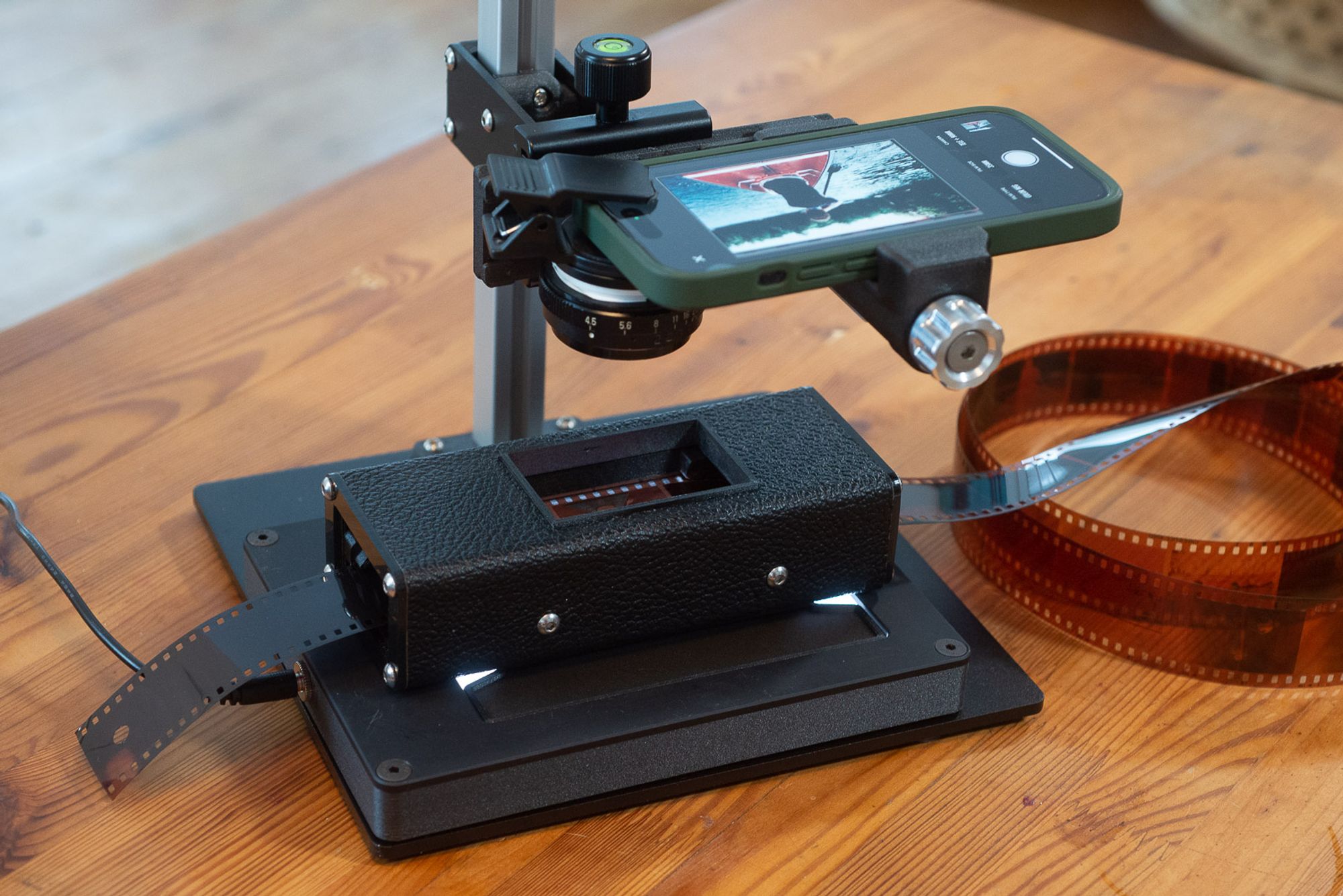 FilmLab 2.5 in a high quality mobile scanning setup. Equipment shown: Negative Supply Riser Mini, Basic 35mm Carrier, and Light Source Basic. Extra lens is a Tominon 90mm enlarger lens adapted to fit a 37mm clip.