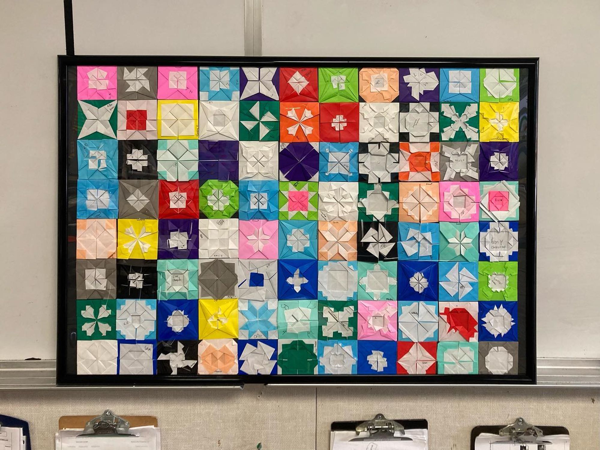 From a one week origami workshop with 7-12th graders. We learned the basics of origami, folded models the students were interested in and combined all of their experience to create this mosaic. Based on Froebel Squares, I taught students how to fold the windmill base and then they created their own symmetrical pattern.