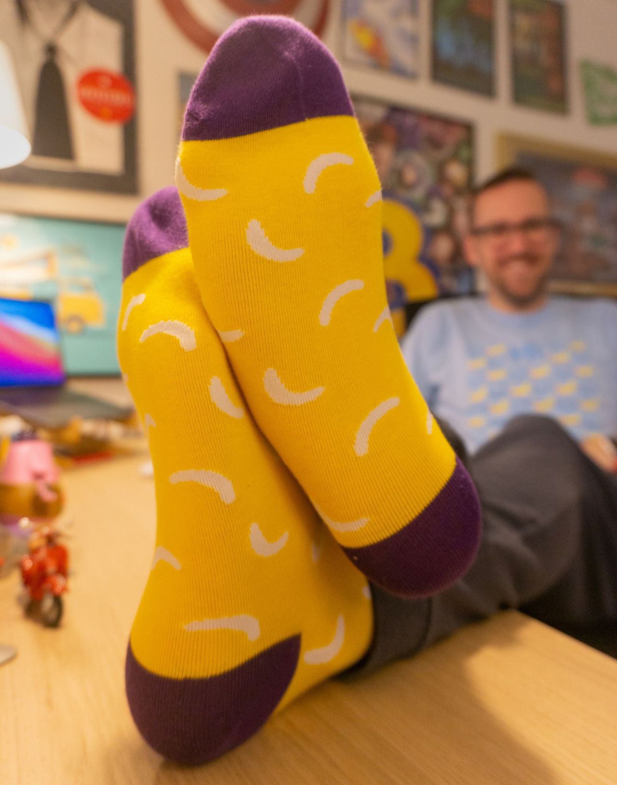 Photo of me with my feet up on my desk, proudly displaying my Bananatag SOC socks