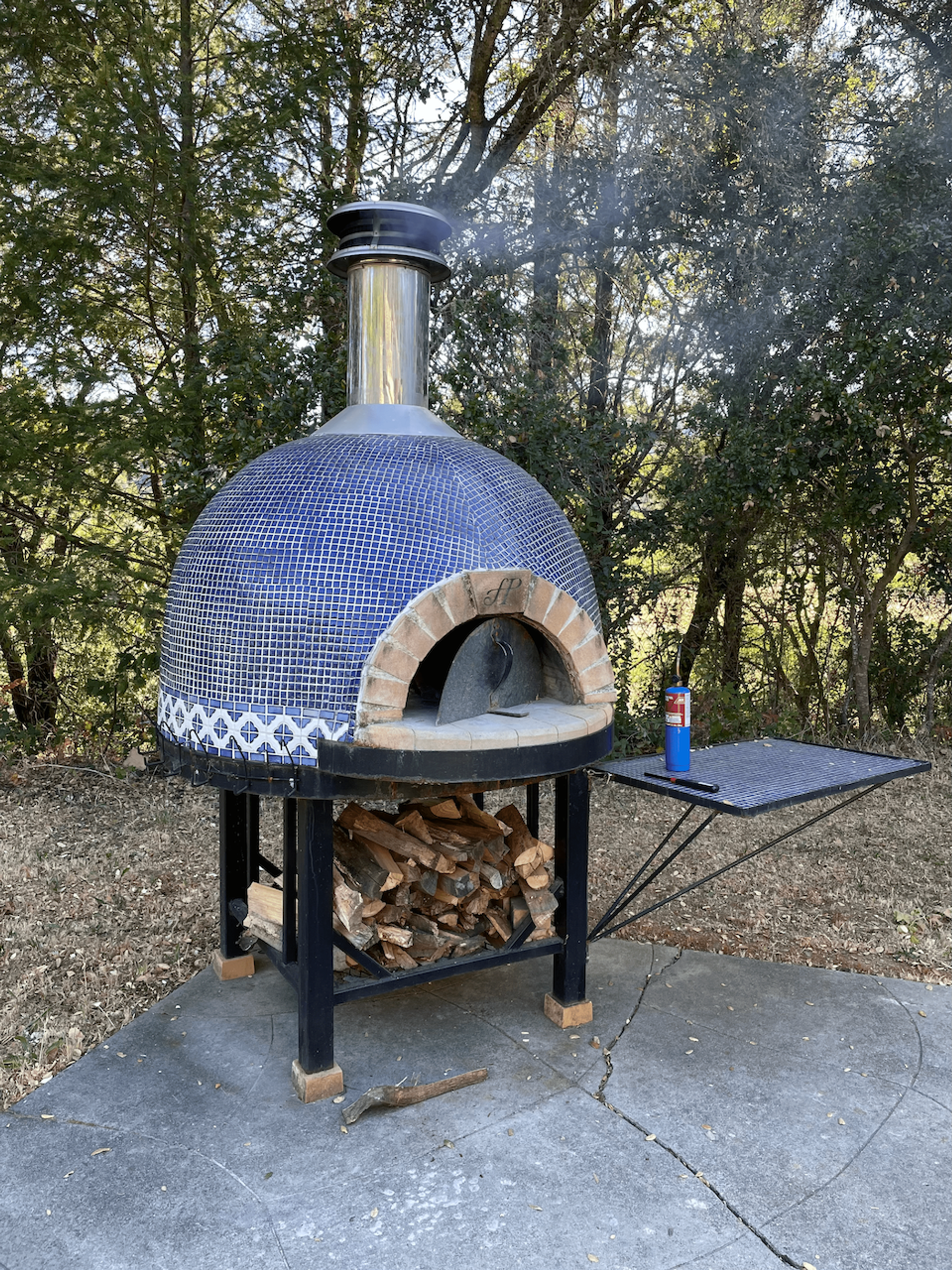 Manning the wood burning pizza oven in Sonoma, CA - Summer 2021
